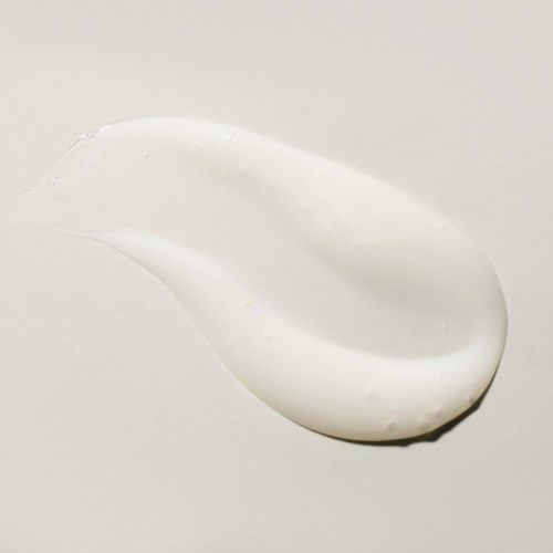 A splash of white cream or lotion on a plain background.