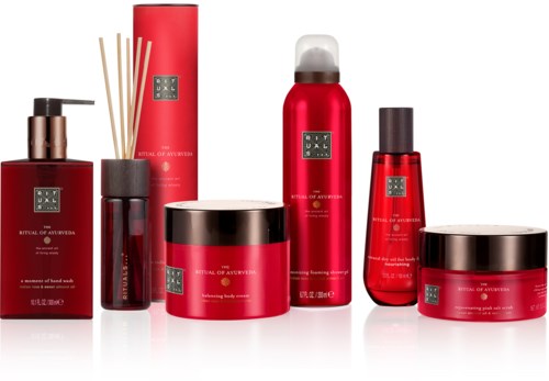 A collection of skincare products in red and black containers, including creams, sprays, and diffusers.