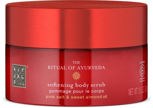 Red jar of Ayurvedic body scrub with salt and almond oil, labeled 'Ritual of Ayurveda.'