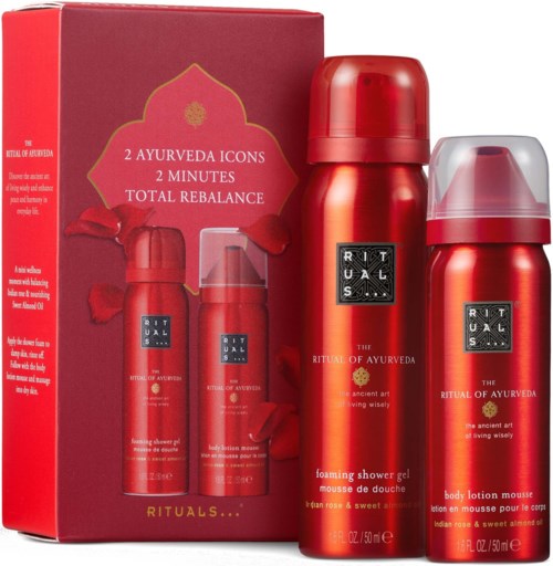 A gift set with red and silver bottles of Ayurveda-themed shower gel and body lotion, with a decorative box.