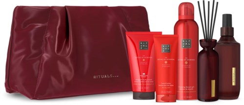 A set of red beauty products including bottles, tubes, and a diffuser with a matching red bag.