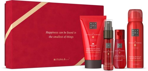 Set of red skincare and body care products with a gift box, including creams and sprays.