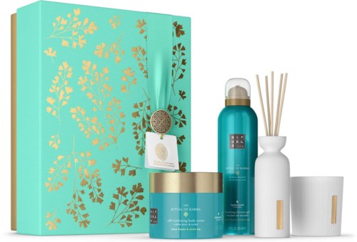Ett hudvårdsset med en teal box, flaskor, en burk och rökelsestavar, alla i matchande design.