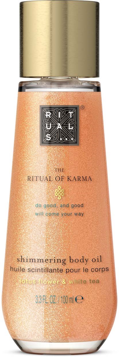 En flaske med glitrende kroppsolje med gullhette og ferskenfarget væske, merket The Ritual of Karma.