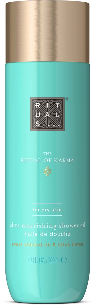 Een aqua blauwe fles met gouden dop, gemarkeerd als Ritual of Karma doucheolie voor een droge huid met amandel en lotusbloem.