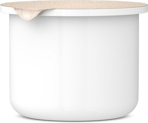 A white rounded container with a wooden lid that has some cream or lotion spilling over the edge.