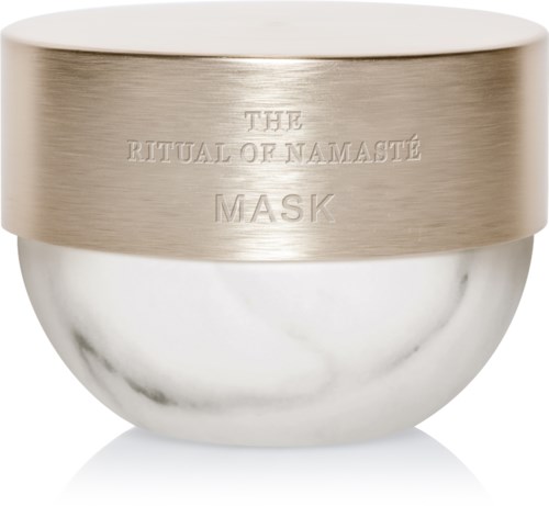 En sølv- og hvit krukke med ordene 'The Ritual of Namasté Mask' på lokket.