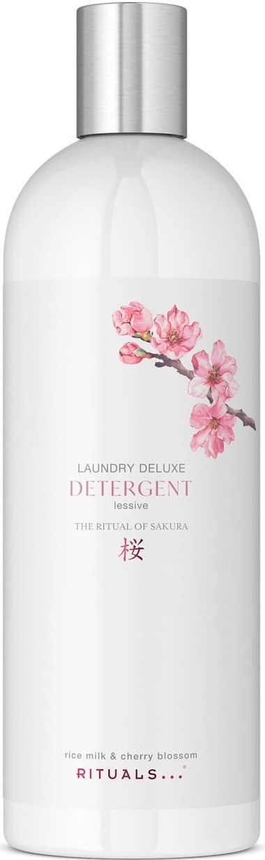 En hvit flaske med sølvkork og rosa kirsebærblomst-design, merket som vaskemiddel med sakura-tema.