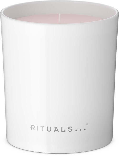 Ett vitt ljus med rosa vax inuti och ordet 'RITUALS...' tryckt på det.
