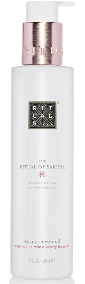 En hvit flaske med rosa pumpe inneholder dusjolje, merket "Ritual of Sakura" med kirsebærblomstduft.