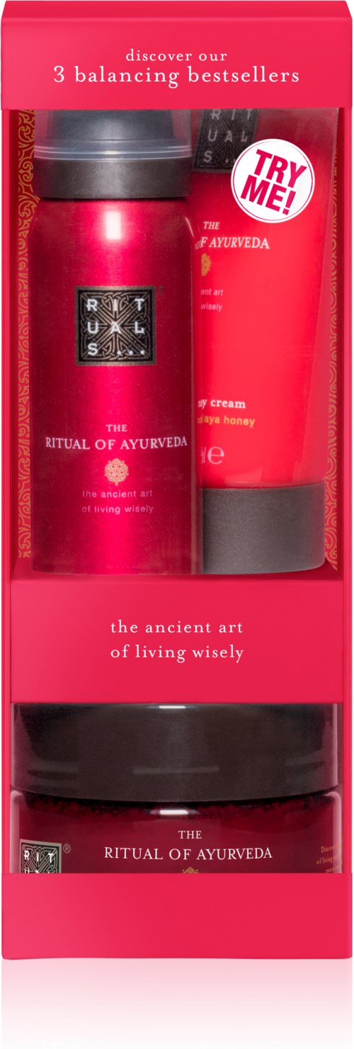Setet inkluderar en röd flaska, ett rött rör och en svart burk, alla med Ayurvedamärken och etiketter.