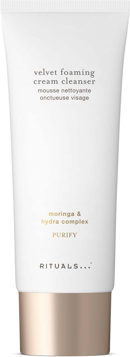 En hvit tube med gullkork, merket som Velvet Foaming Cream Cleanser med naturlige ingredienser.