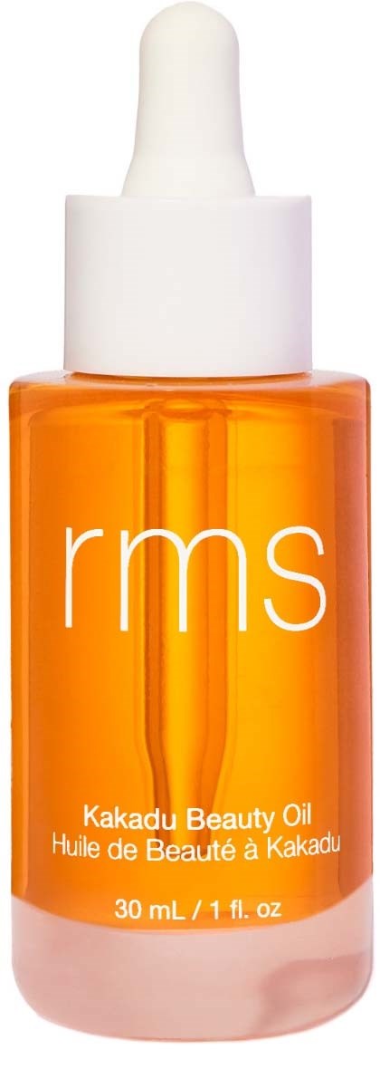 Orange bottle with a white dropper cap and 'rms' logo, featuring Kakadu Beauty Oil label.