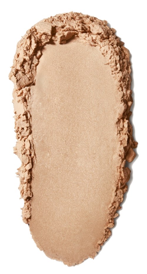 A beige powder spread in an oval shape with rough edges, likely makeup or cosmetic powder.