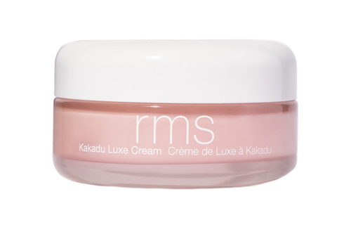 Różowy pojemnik na krem, z białą pokrywą, oznaczony 'rms Kakadu Luxe Cream'.