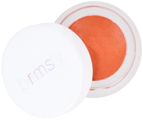 A small round container with white lid, open to show orange cream inside.