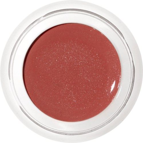 En rund behållare med rödaktig makeup eller nagellack, glittrande med små glitterpartiklar.
