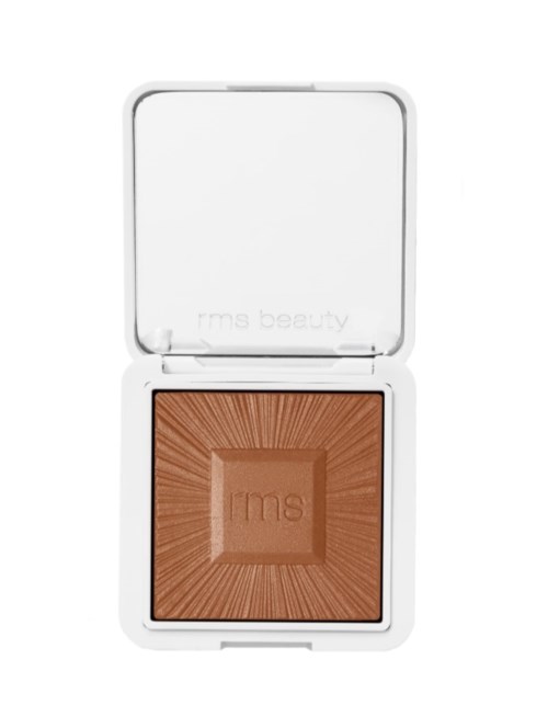 A makeup compact with a bronzer inside, in a white case with a mirror.