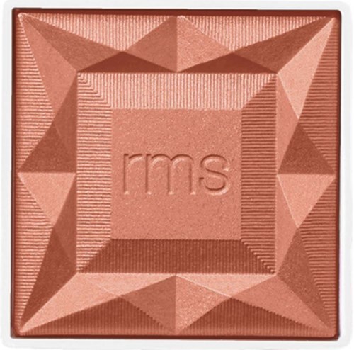 A square bronzed compact with geometric patterns and the letters 'rms' in the center.