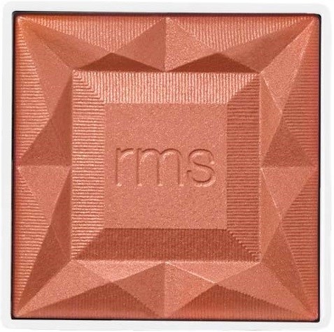 A pinkish-brown square makeup blush with geometric patterns and the letters "rms" in the center.