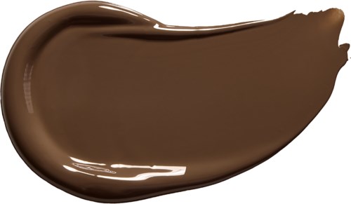 A blob of creamy, glossy brown substance, shaped like a teardrop or elongated oval.