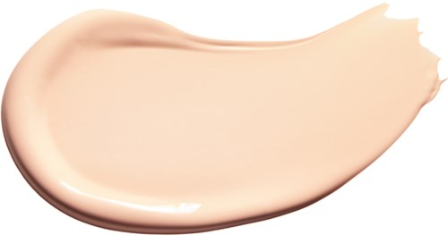 A streak of light beige liquid makeup with a smooth, creamy texture on a white background.