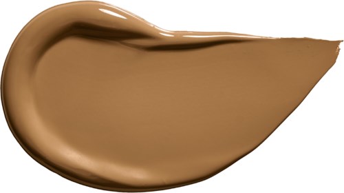 A swatch of beige liquid foundation or concealer with a smooth, thick texture, shaped in a droplet form.