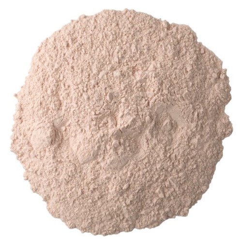 A pile of light beige powder with a rough, uneven surface, likely a type of flour or ground material.
