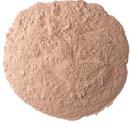 A round, light brown powdery substance with a slightly uneven surface.