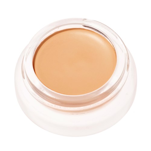 En liten burk med beige-färgad foundation eller kräm utan synlig etikett.