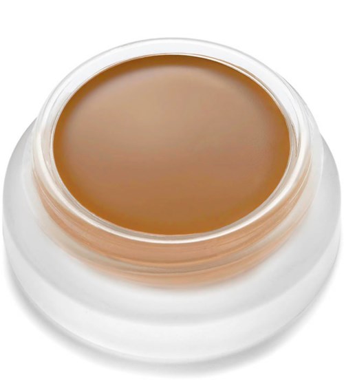 A small jar of light brown cream or gel with a clear, open top, placed on a white surface.