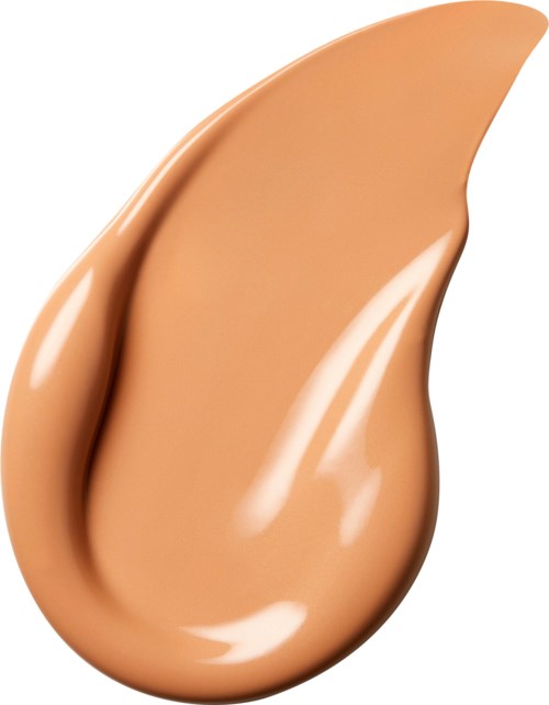 En droppe av beige flytande med slät, glänsande yta och kurvig form.