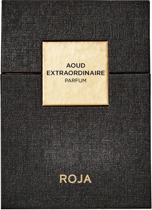 A perfume box with a black textured surface and a cream-colored square label. The label has French words and the name 'ROJA'.