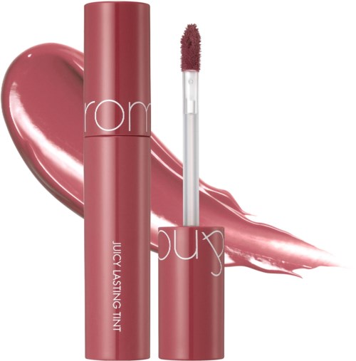 A pink lip gloss tube with the words 'Juicy Lasting Tint' and a smudged pink lipstick mark.