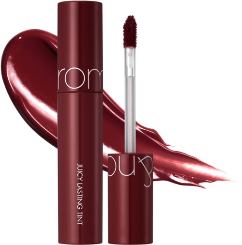 A lipstick tube with a matching brush, with red lipstick swiped behind it, labeled Juicy Lasting Tint by Rom.&nbsp;