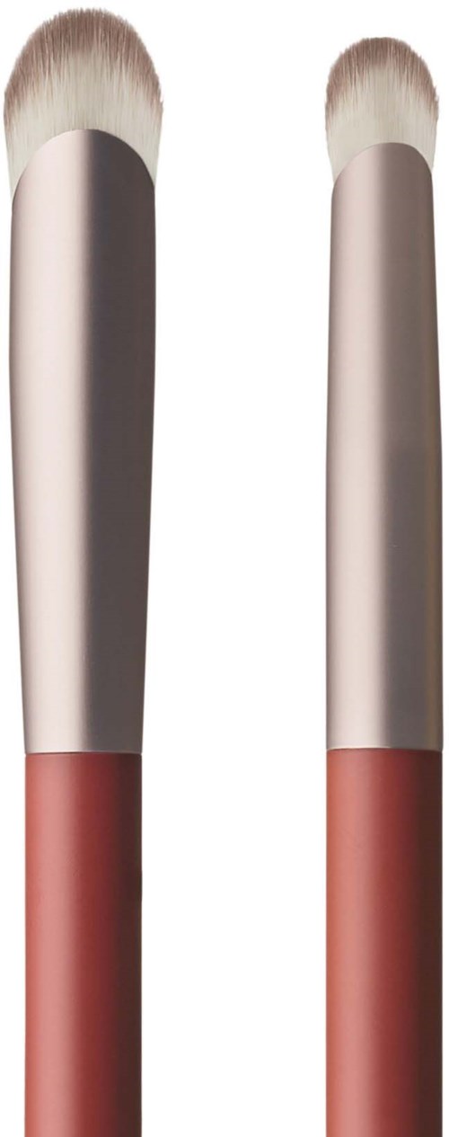 Two makeup brushes with white bristles and pink handles.