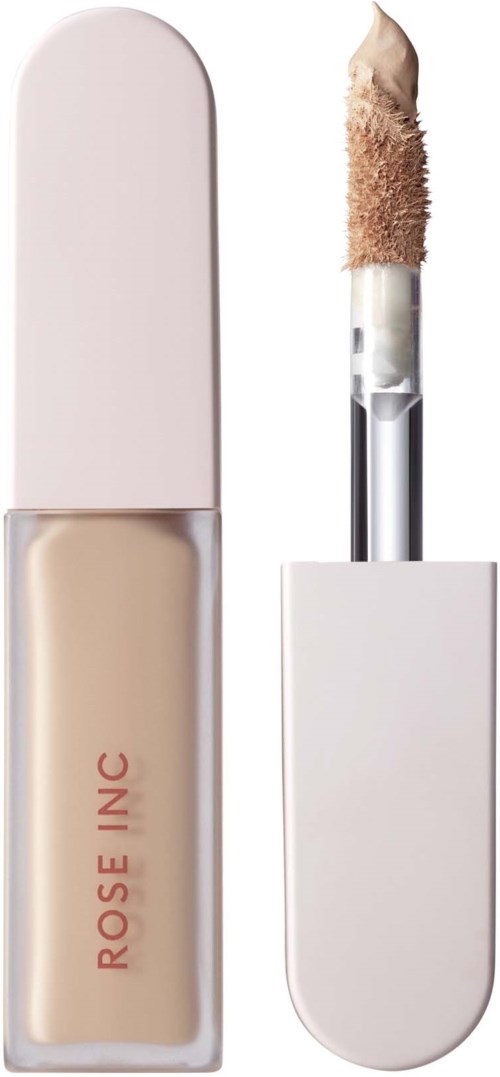 Ett makeup-blekningsmedel med vit lock och beige vätska inuti, märkt 'ROSE INC' på flaskan.