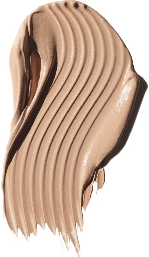 En sträng av beige flytande makeupprodukt med ränder och kurvor, visar en slät, krämig textur.