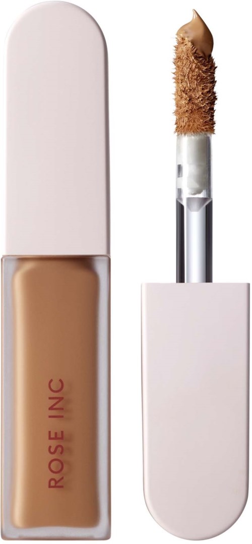En beige flytande concealer i en liten flaska med vit lock och en applikator med lite produkt på.