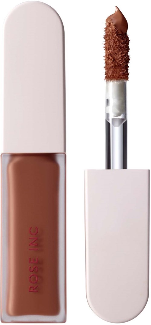 Eine flüssige Foundation in einer klaren Flasche mit weißem Deckel und Applikator mit braunem Schwammtip.