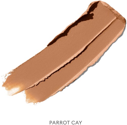 En beige sminkestift merket 'Parrot Cay' med en litt rødaktig tone og en teksturert overflate.
