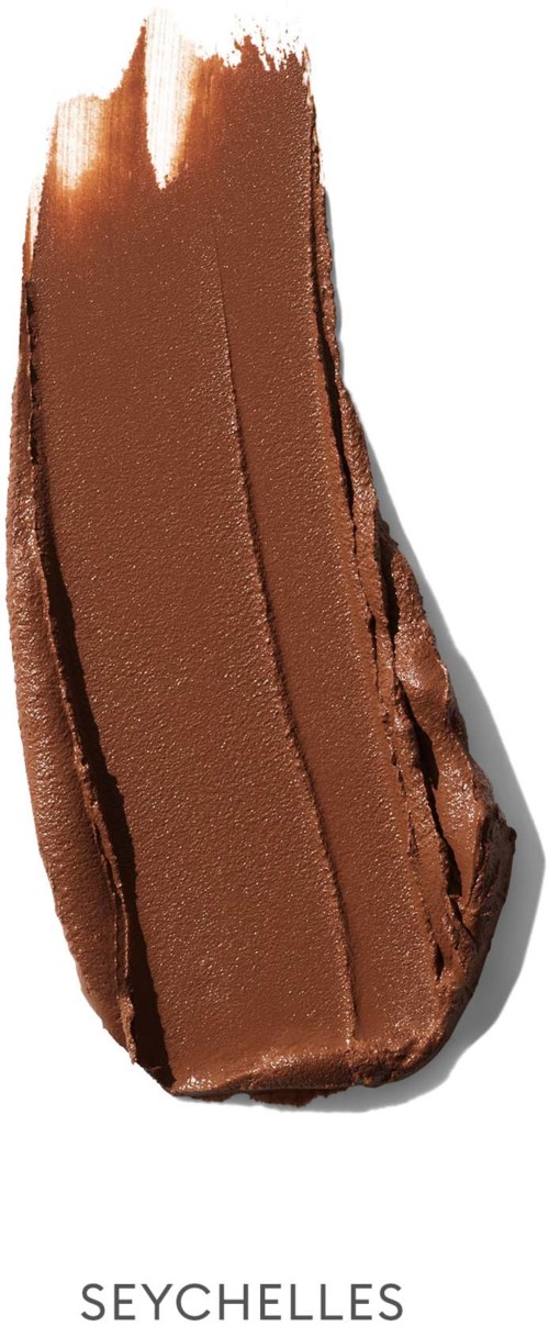 A brown seashell with a rough textured surface and a pointed tip, casting a shadow to the right.