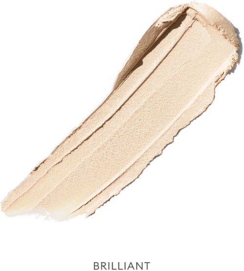 Ein Streifen cremiger beiger Make-up-Produktion, wahrscheinlich Foundation oder Concealer, auf weißem Hintergrund.