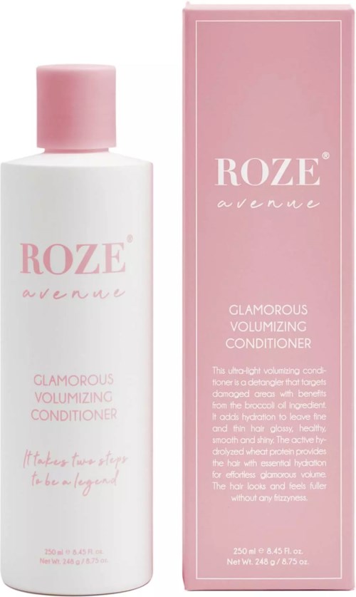 Een witte fles met roze dop en een roze doos erachter, beide gelabeld 'Roze avenue' en 'Glamorous Volumizing Conditioner'.