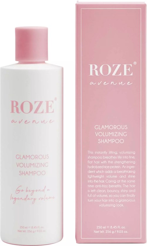 En vit flaska och rosa låda för Roze Avenue Glamorous Volumizing Shampoo, med mjuka rosa texter och design.