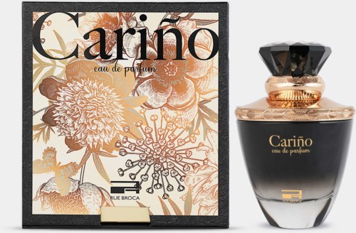 Een parfumfles en doos met bloemmotief en gouden details, gemerkt 'Cariño'.