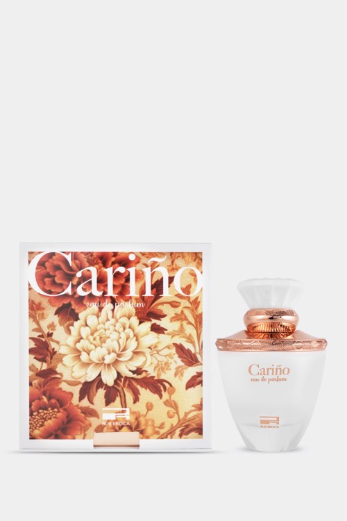 Een parfumfles en doos met het woord "Cariño" en bloemendesign op de doos.
