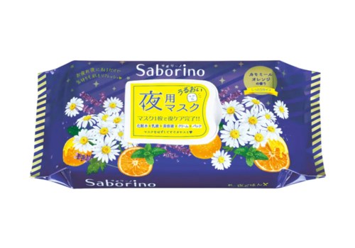 Sininen paketti, jossa valkoisia kukkia, appelsiineja ja japaninkielistä tekstiä, luultavasti kasvomaskituote.