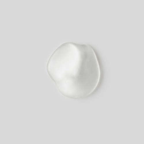 A white, irregularly shaped object on a gray background, resembling a blob or soft material.