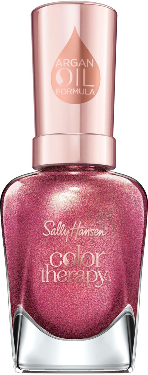 En mörk rosa nagellackflaska med glänsande lock och vit text, märkt 'Color Therapy' av Sally Hansen.